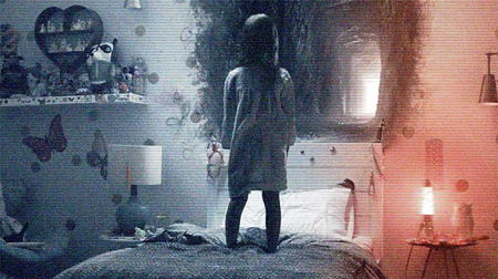 A small girl stands on her bed, as a portal opens on the wall above her headrest.