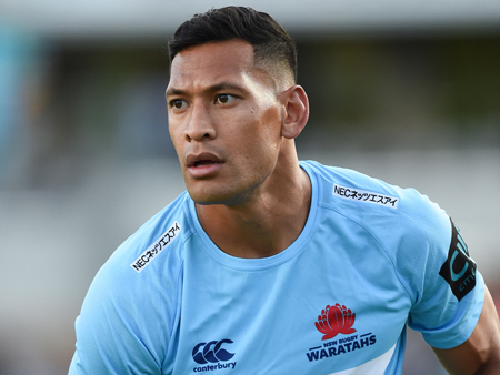 Israel Folau looks off camera as he is on field playing rugby.