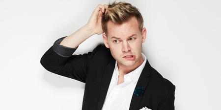 Joel Creasey scratches his head and twists his mouth during a photo shoot.