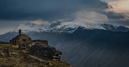 A mountain range is seen from a hill top in Wales.