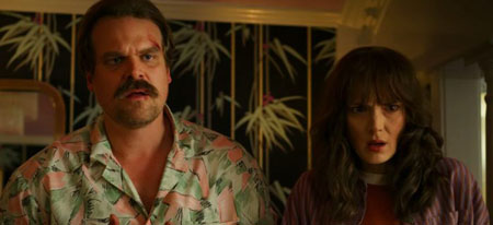 Hopper and Joyce look with disbelief at something off screen.
