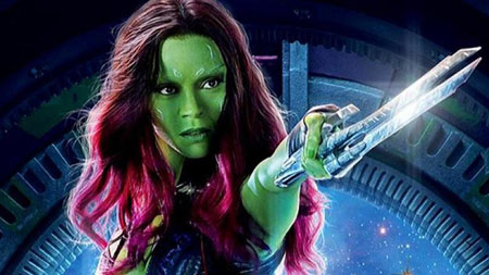 Gamora points a sword at someone off screen.