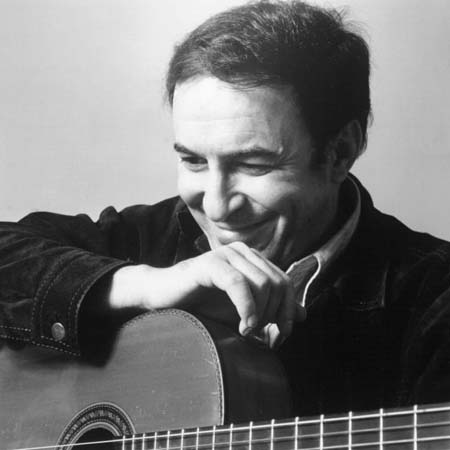Joao Gilberto is seen holding a guitar and looking down.