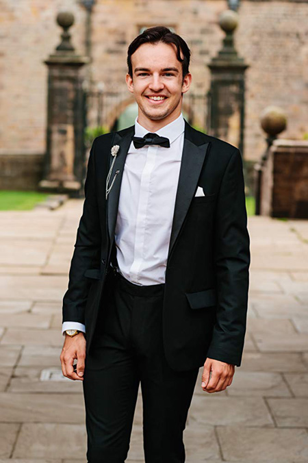 Cometan dressed in a tuxedo attending his 21st birthday party at an English castle and stately home.