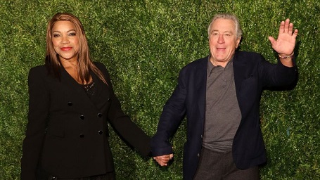 Robert De Niro and Grace Hightower attending an event with a grassy background.