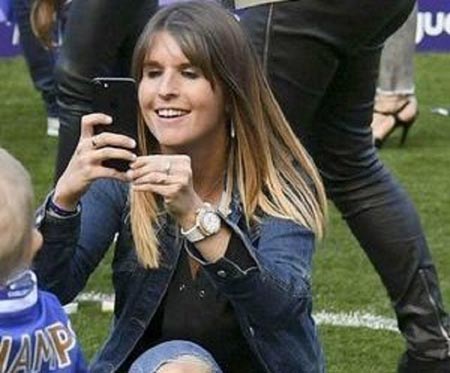 Natacha Van Honacker on the pitch taking pictures of her children and husband.