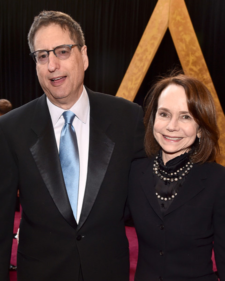 Tom Rothman puts his hand around his wife Jessica Harper on the red carpet.