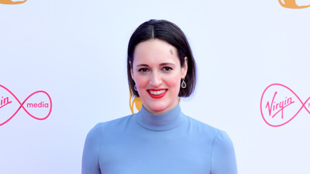 Phoebe Waller-Bridge at a red carpet event wearing a blue high-neck.