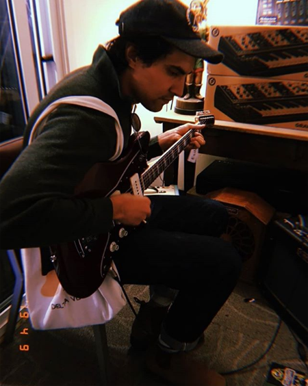 Kamran Fulleylove playing a guitar