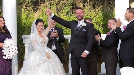 Mathews raising Farley's hand just after they were announced husband and wife.