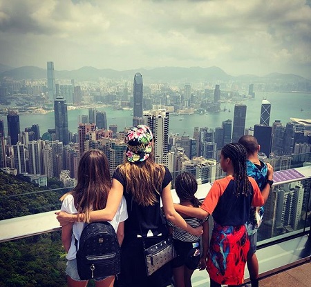 Heidi Klum and her four kids back in back on top of a tower in Hong Kong.