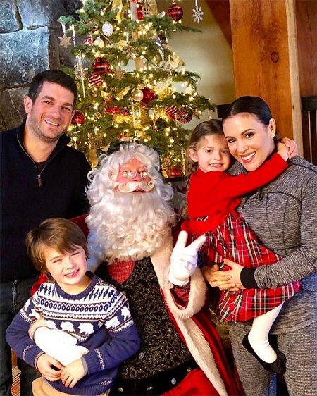 "Merry Christmas from our family to yours," Milano wrote on Instagram on Christmas Eve 2017 alongside a snapshot of daughter Elizabella and son Milo, with husband Bugliari also in the photo with Santa. 