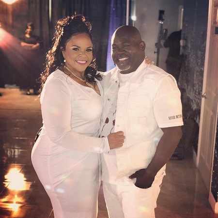 David and Tamela Mann in white dresses in the night and smiling together.