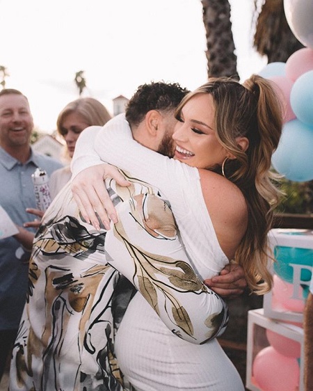 Cory Wharton (face hidden) hugging his girlfriend Taylor Selfridge at their baby shower.