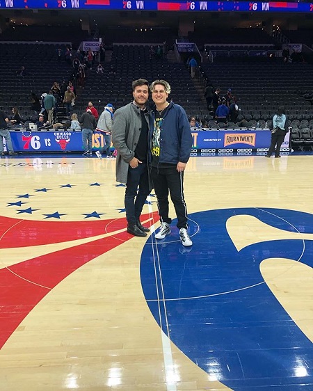 Anthony Lario and his brother Dominic Lario standing at the center of aa basketball court.