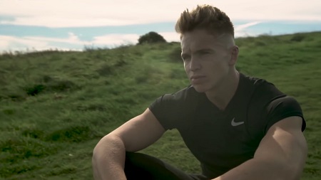 Joe Weller sitting and looking motionless and unexpressioned.
