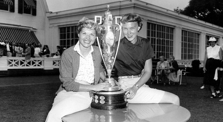 In this Sept. 17, 1954, file photo, Barbara Romack, left, and Mickey Wright pose with the championship cup after defeating their respective opponents to enter the final round of the Women's National Golf Championship, in Pittsburgh, Pa.