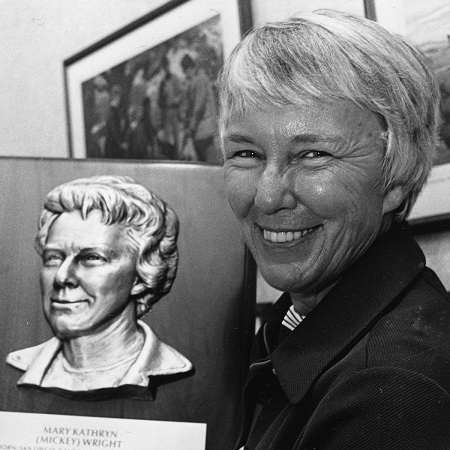 Mickey Wright holding a portrait of hers.