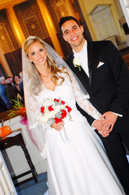 Kelly Ann Cicalese, with her husband, Edward Davila, in their wedding dresses.