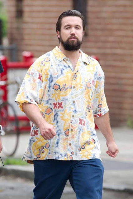 Rob McElhenney walking about in a Hawaiian shirt.