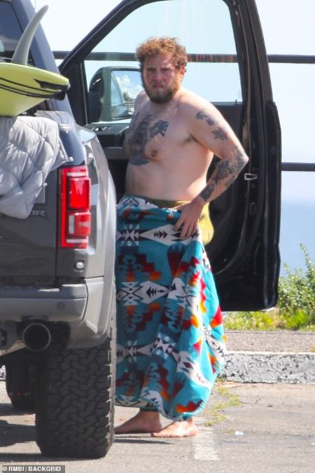 Jonah Hills showing off his tattoos