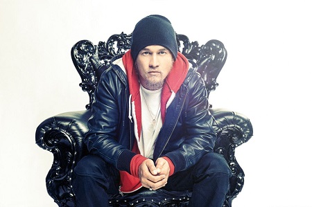 Souleye in a chair in a hiphop attire.