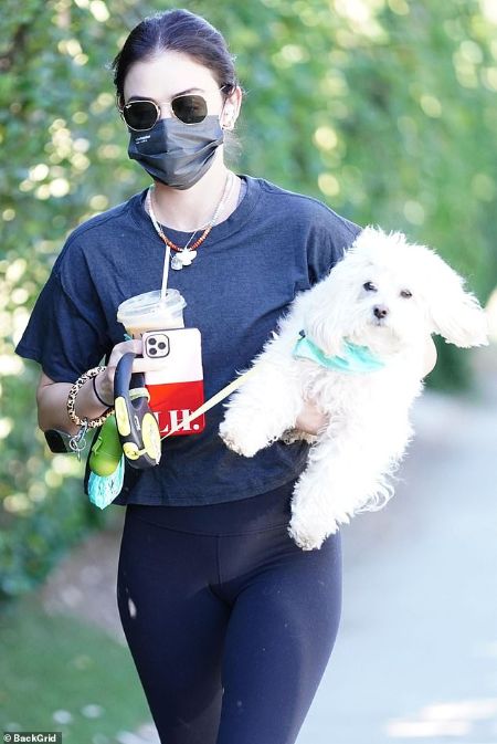 Lucy Hale with her dog Elvis on a walk.