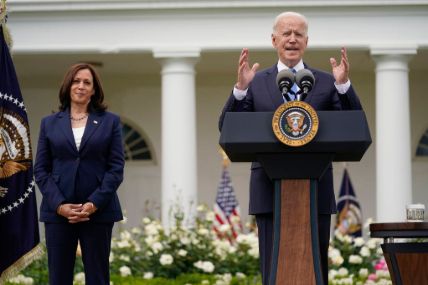 President Joe Biden and Kamala Harris unmasked celebrating the new milestone.