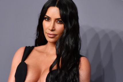 Kim Kardashian posing during an award ceremony.