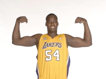 Kwame Brown posing in his Lakers Jersey.