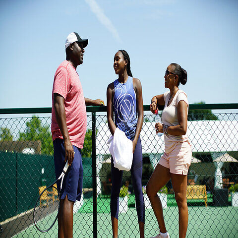 Coco Gauff chatting with her parents