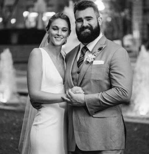 Jason Kelce and Kylie McDevitt walk in aisle in 2019