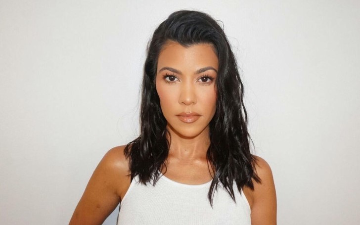 Kourtney Kardashian Looks Gorgeous As She Poses In Striped Robe While Her Stylist Glams Her Up